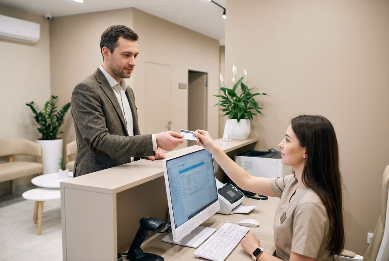Patient showing insurance card at medical reception desk